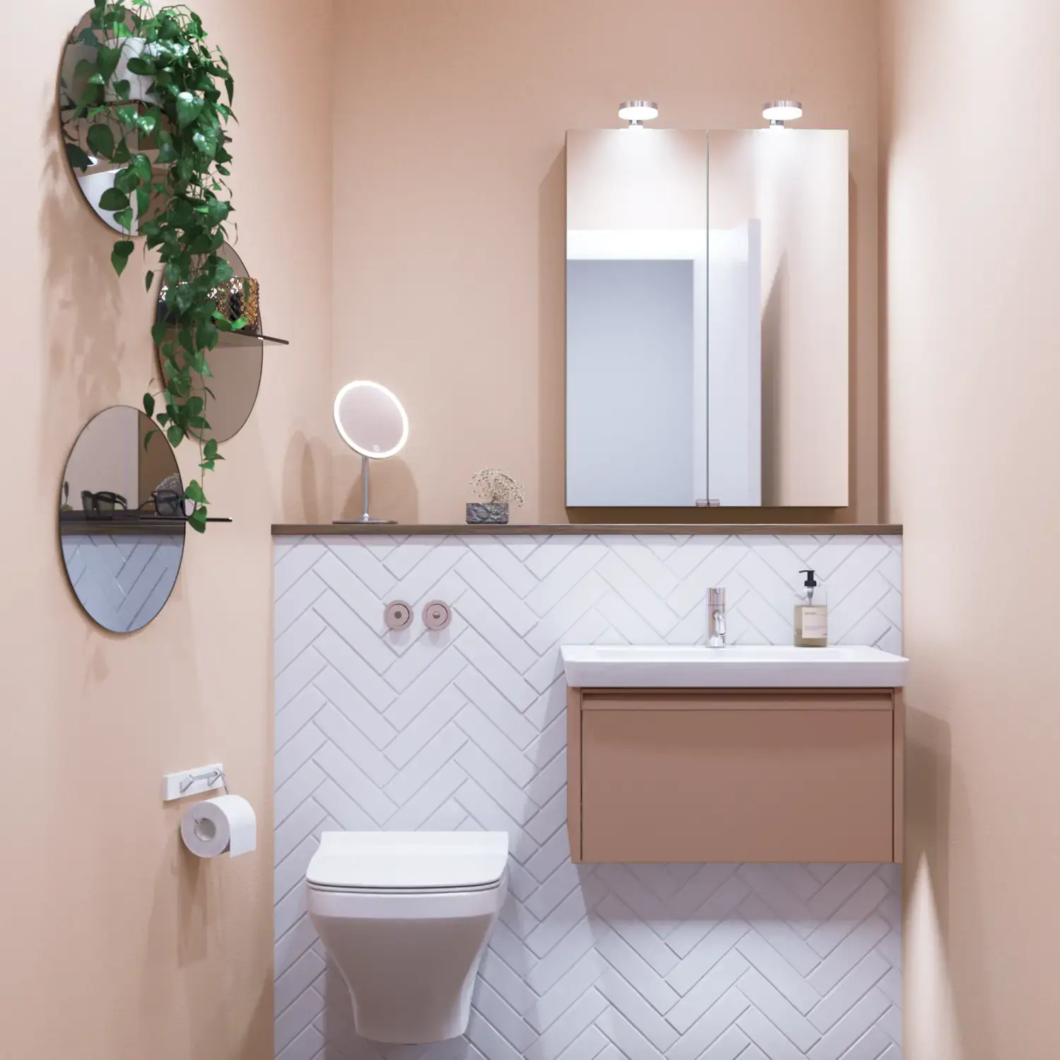 Lille badeværelse inspiration med lille vaskeskab i specialfarve med integreret greb, spejlskab med lamper, dekorationsspejl med tonet glashylde, hvide sildebensfliser på væggen giver et stilrent og klassisk udtryk.